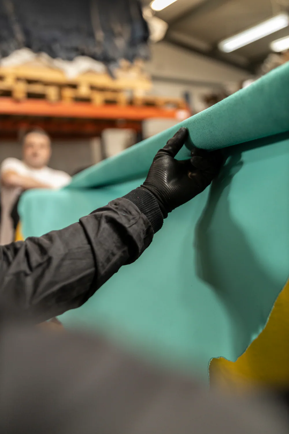 Inspecting turquoise leather in the Kravczyk workshop