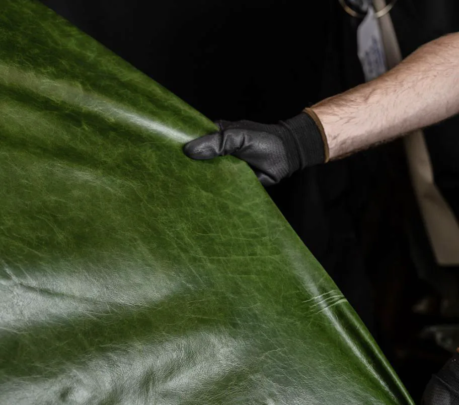 Worker presenting a sheet of green natural leather